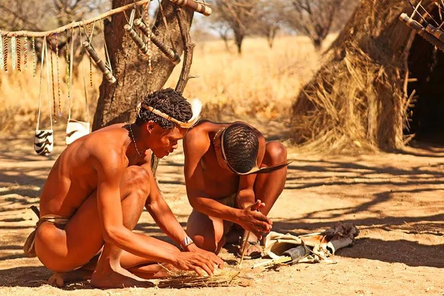 Bushmen tribe men making fire the traditional way