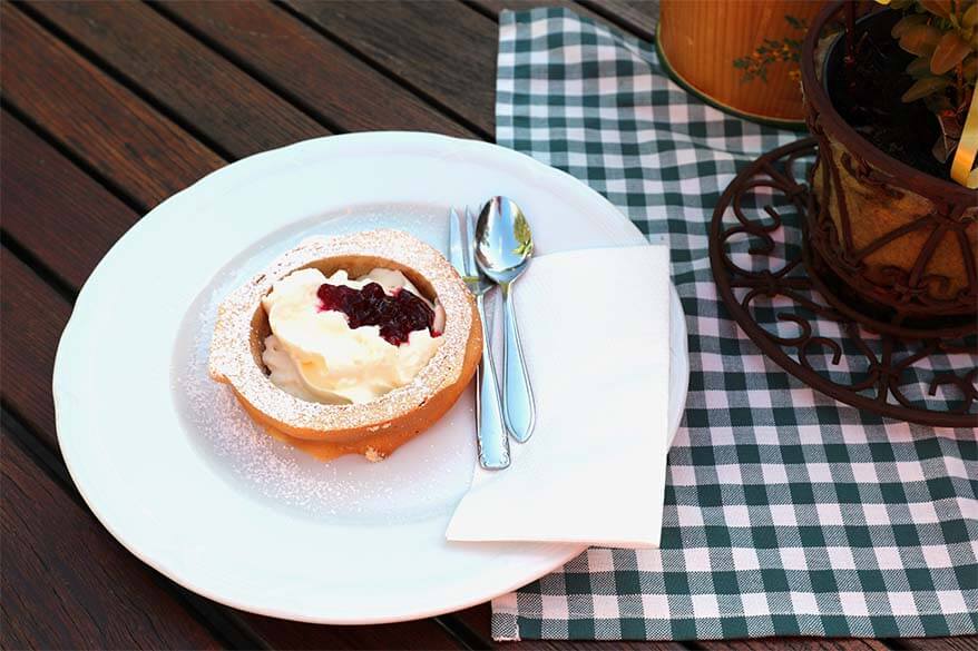 Austrian Prugeltorte served with whipped cream and cranberry sauce