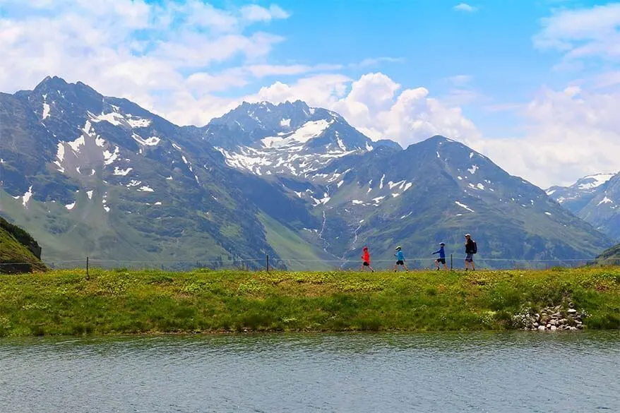 Family with kids hiking on the Mutspuren trail in St Anton in Tyrol Austria