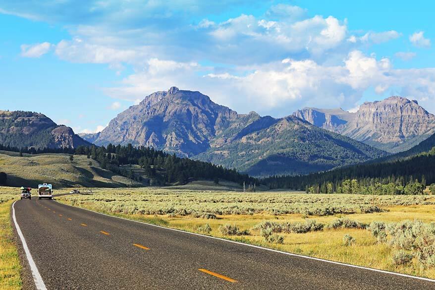 Scenic road with mountain views leading from Lamar Valley to the Northeast Entrance Gate of Yellowstone