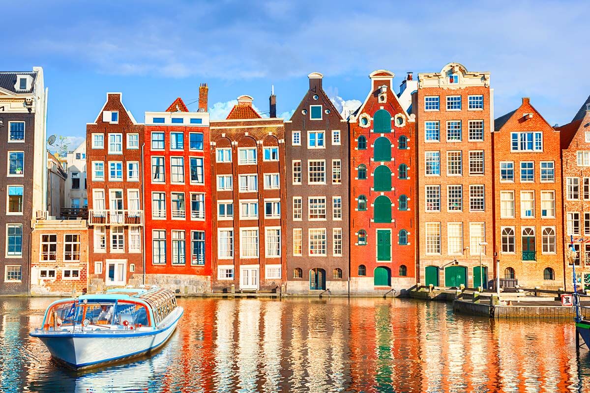 Colorful houses at Damrak waterfront in Amsterdam