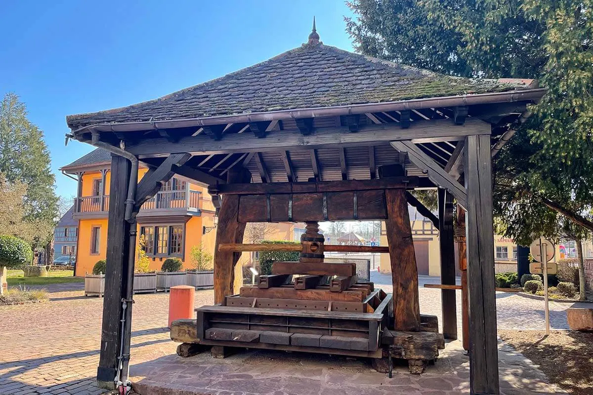 Old wooden wine press at Maison Wolfberger in Eguisheim France