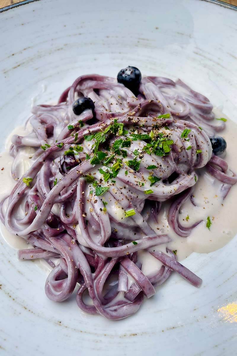 Traditional blueberry pasta at a restaurant in Lake Como Italy