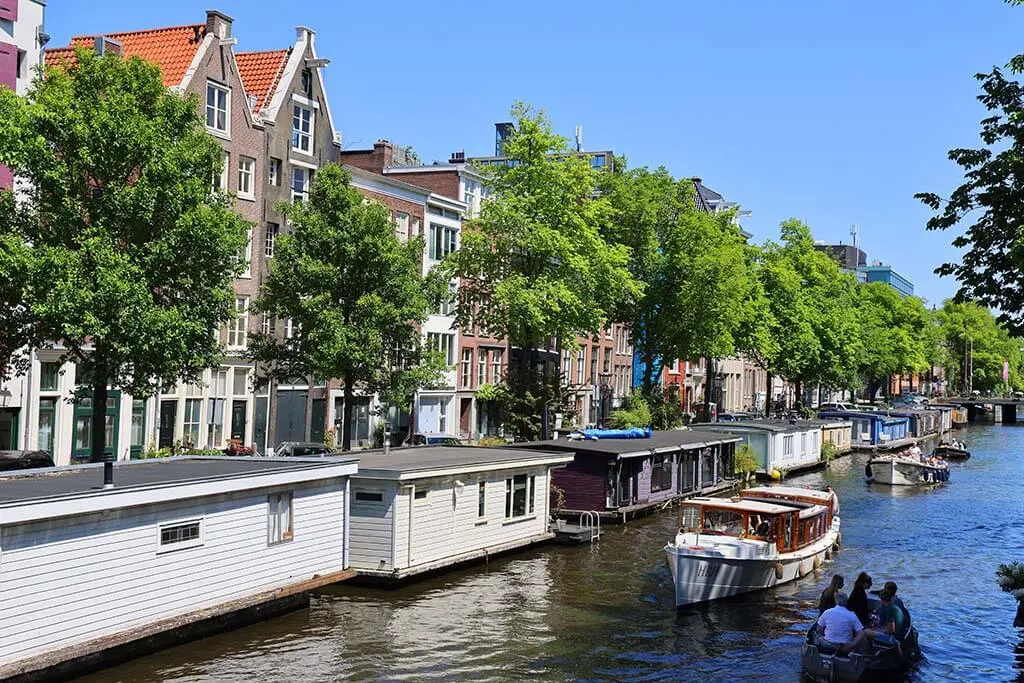 Boats on Amsterdam canals on a sunny summer day in June