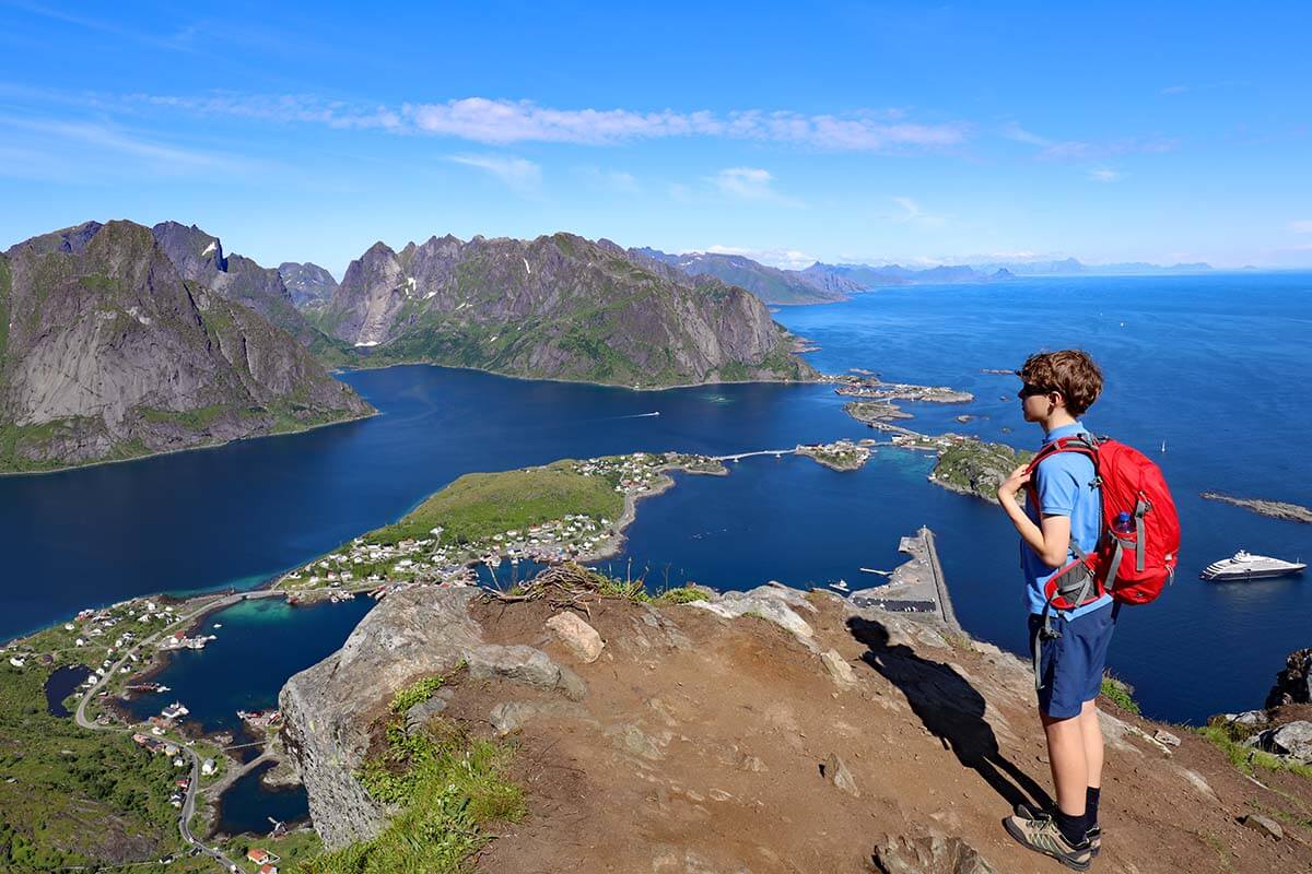 Boy wearing shorts and t-shirt at Reinebringen hike in Lofoten in summer