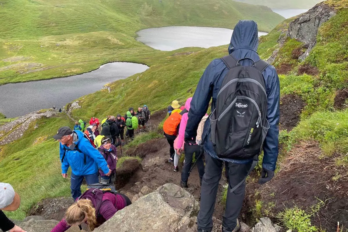 Crowds at Ryten hiking trail in Lofoten on a rainy summer day