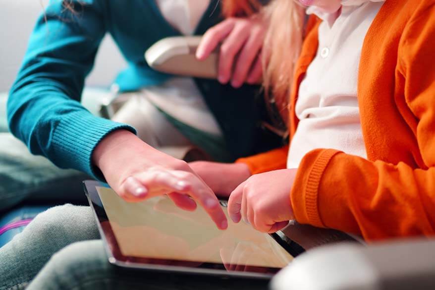 Kids using digital tablet on the plane